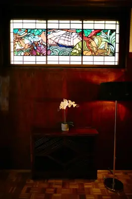 a stained glass window with a vase of flowers on a table at Hotel Majestic in Belgrade
