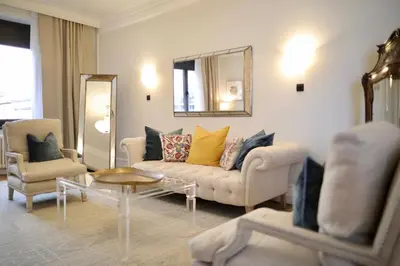 a living room with a couch and a mirror at Hotel Majestic in Belgrade