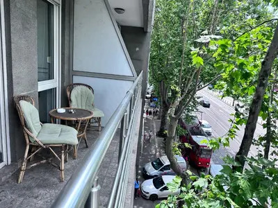 a balcony with two chairs and a table on a building at BASE Accommodation Apartments in Belgrade