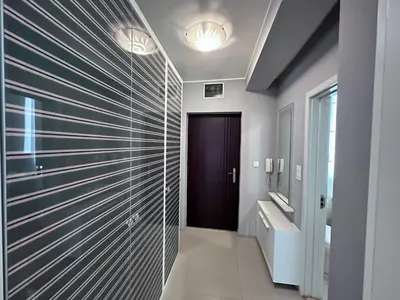 a bathroom with a hallway with a glass wall at BASE Accommodation Apartments in Belgrade