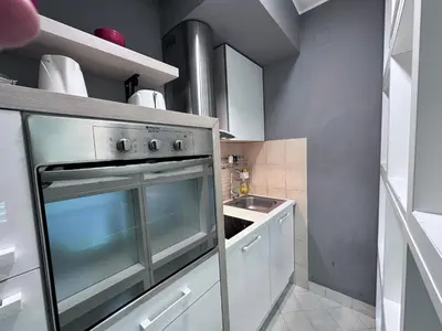 a kitchen with a stainless steel oven and a sink at BASE Accommodation Apartments in Belgrade
