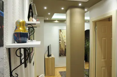 a hallway with a door and a vase on a shelf at Apartment D-22 in Belgrade