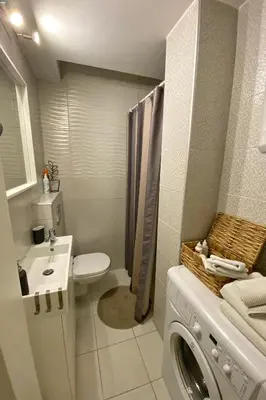 a bathroom with a washing machine and a washer at Apartment D-22 in Belgrade