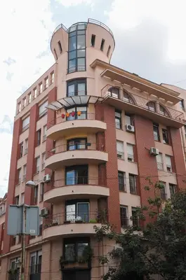 a tall red brick building with balconies on it at Apartment D-22 in Belgrade