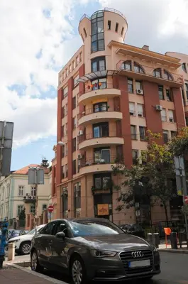 a car parked in front of a tall building at Apartment D-22 in Belgrade