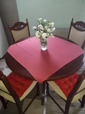 a pink table with a vase of flowers on it at Airport apartment T&T in Surčin