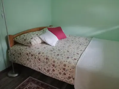a bed with a pillow on top of it at Airport apartment T&T in Surčin