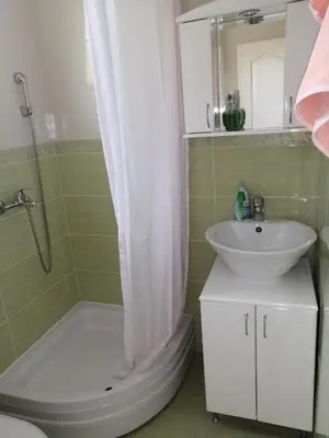 a bathroom with a sink and a toilet and a shower at Airport apartment T&T in Surčin