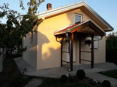 a small yellow house with an awning on it at Airport apartment T&T in Surčin