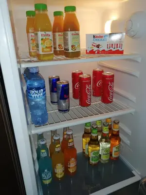 a refrigerator filled with lots of drinks and soda at Airport apartment T&T in Surčin