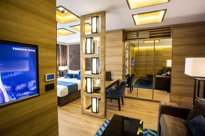 a hotel room with a bed and a living room at Eden Luxury Suites Terazije in Belgrade