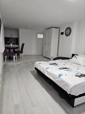 a bedroom with a bed and a table and chairs at Studio Dana in Arandjelovac