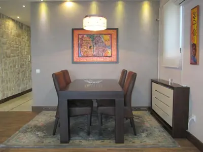 a dining room with a table and chairs at Genex Apartment in Belgrade