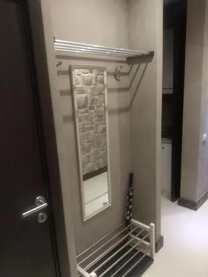 a mirror on a wall next to a door at Genex Apartment in Belgrade