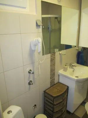 a bathroom with a sink and a toilet and a phone at Genex Apartment in Belgrade