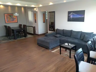 a living room with a couch and a table at Genex Apartment in Belgrade