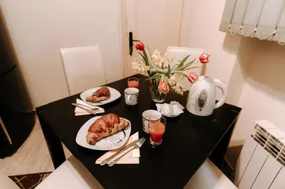 a black table with two plates of food on it at Apartman Milenijum in Belgrade