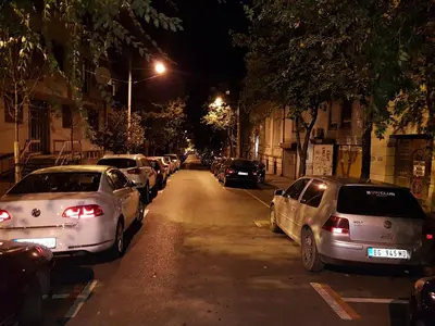 a row of cars parked on a street at night at Apartment Aleksandar in Belgrade