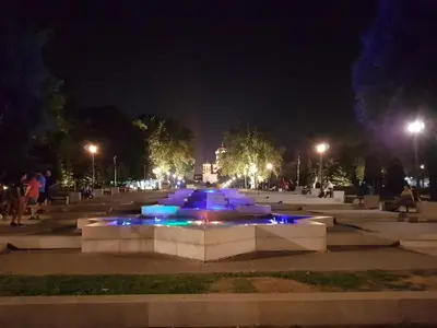 a fountain in a park at night at Apartment Aleksandar in Belgrade