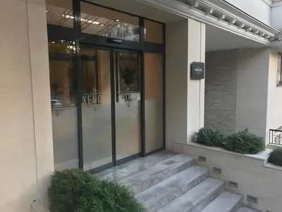 a glass door of a building with stairs in front at Xenon Hotel & SPA in Belgrade