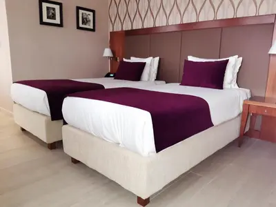 a bedroom with two beds and a large bed at Xenon Hotel & SPA in Belgrade