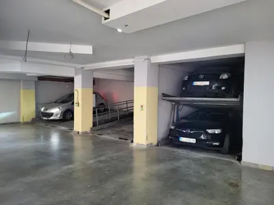 two cars are parked in a parking garage at Xenon Hotel & SPA in Belgrade
