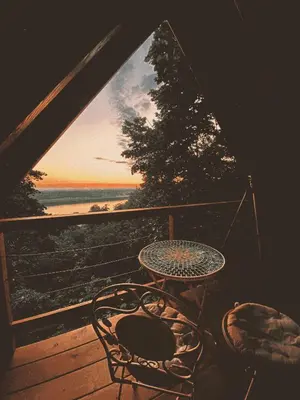 a table and chairs on a porch with a view of the ocean at Laguna Platz in Sremski Karlovci
