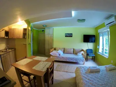 a living room with a couch and a table at Apartments Popovic in Belgrade