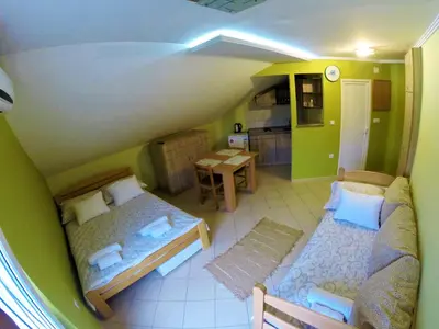 a small room with two beds and a kitchen at Apartments Popovic in Belgrade