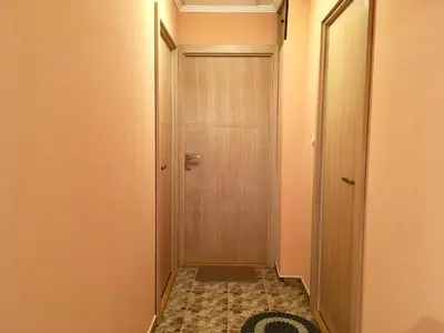 a hallway with a door and a tile floor at Apartments Popovic in Belgrade