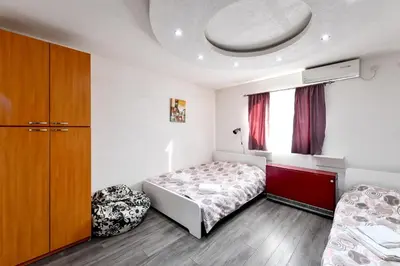 a small bedroom with a bed and a window at Central Monument Apartment Bojkovic in Belgrade