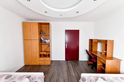 a room with a desk and a red door at Central Monument Apartment Bojkovic in Belgrade