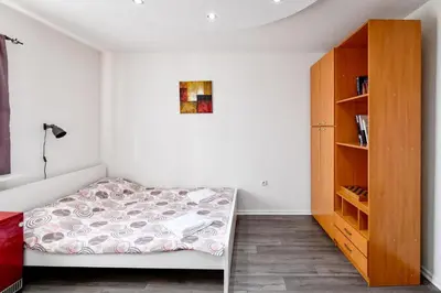 a bedroom with a bed and a book shelf at Central Monument Apartment Bojkovic in Belgrade