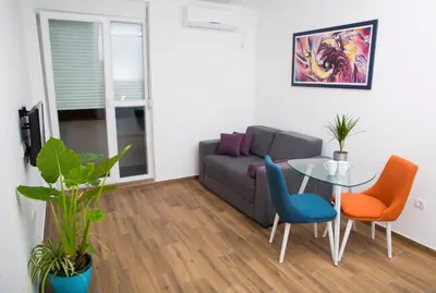 a living room with a couch and a glass table at Apartment Koral in Ruma