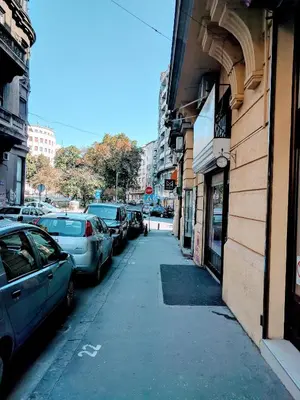 a street with cars parked next to a building at Cozy Central Studio - Steps from Knez Mihailova in Belgrade