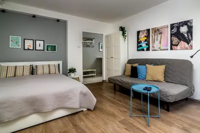 a bedroom with a bed and a couch at Cozy Central Studio - Steps from Knez Mihailova in Belgrade