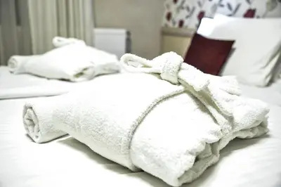 a white towel sitting on top of a bed at Hotel Centar Balasevic in Belgrade