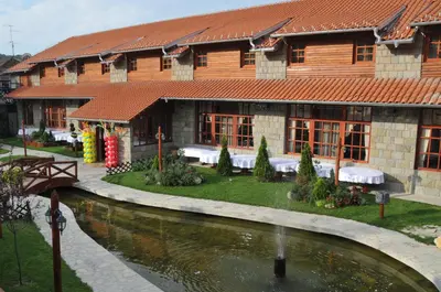 a building with a pond in front of it at Hotel Centar Balasevic in Belgrade