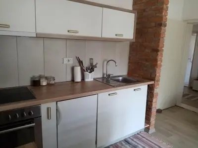 a kitchen with white cabinets and a sink at Apartman Otvoreno polje in Arandjelovac