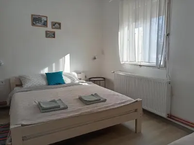 a bedroom with a bed with two towels on it at Apartman Otvoreno polje in Arandjelovac