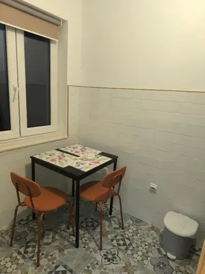 a table and two chairs in a room at Guest House Major in Arandjelovac