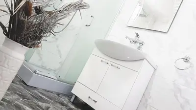 a white bathroom with a sink and a shower at Apartments Villa White House in Pančevo