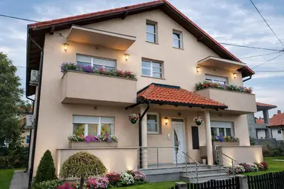 a house with flower boxes on the balconies at President 034 in Arandjelovac