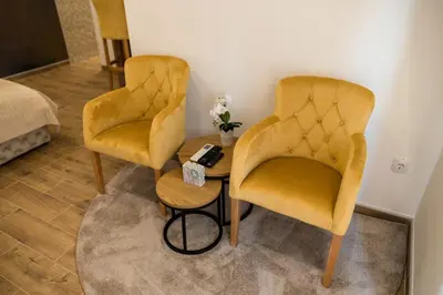 two yellow chairs and a table in a room at President 034 in Arandjelovac
