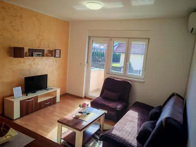 a living room with a couch and a table at President 034 in Arandjelovac