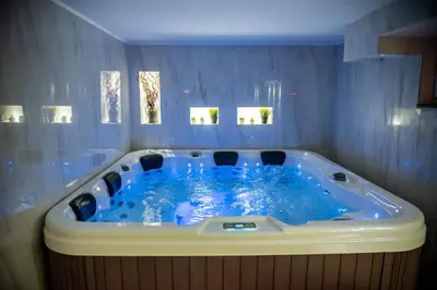a large blue tub with chairs in a room at Vila Mila in Arandjelovac