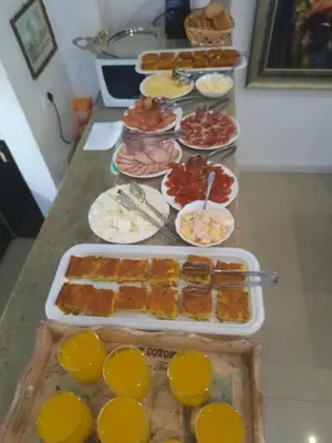 a table with many different types of food on it at Vila Mila in Arandjelovac
