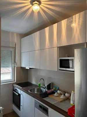 a kitchen with a sink and a microwave at Flat Kosutnjak 9 in Belgrade