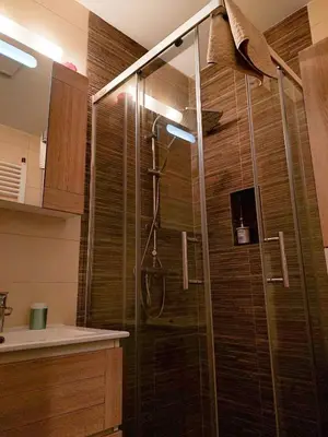 a shower with a glass door in a bathroom at Flat Kosutnjak 9 in Belgrade