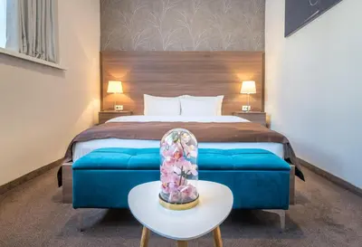 a hotel room with a bed and a table with a table sidx sidx at Veneti Suites in Belgrade